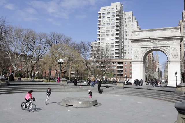 Children ride their scooters inside an empty fountain in Washington Square Park in New York, New York, USA, 22 March 2020.